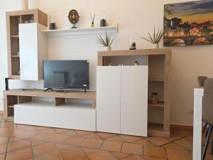 a living room with a white entertainment center with a tv at Liberty House Ten in Rome