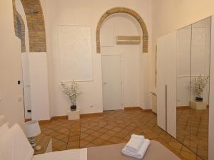 a bathroom with an archway and a room with a sink at Liberty House Ten in Rome +22 photos