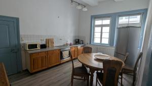 a kitchen with a table and a microwave and a table and chairs at Altstadthaus in Arnsberg