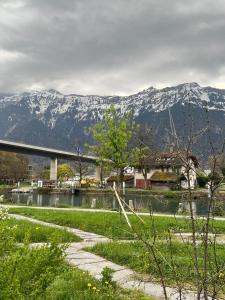 a bridge over a river with mountains in the background at Rawda Ferien Wohnung 2 in Interlaken