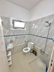 a bathroom with a shower and a toilet and a sink at Appartement Ajdir in Al Hoceïma