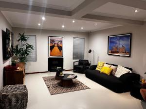 a living room with a couch and a table at Tambula Guest House in Cape Town
