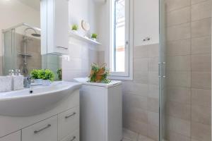a white bathroom with a sink and a shower at NURAS - Casa Aurelia square view old town in Alghero +27 photos