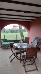 a table and chairs in a room with a patio at Casa Daniela in Velletri