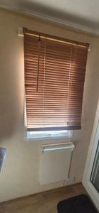 a window in a room with a blind on it at The salsbury lyons robin hood park,rhyl in Meliden