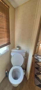 a bathroom with a white toilet in a room at The salsbury lyons robin hood park,rhyl in Meliden +9 photos