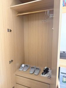 a cabinet with two pairs of shoes in it at Victoria home in Vĩnh Thái