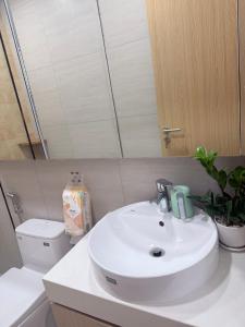 a bathroom with a white sink and a toilet at Victoria home in Vĩnh Thái +3 photos