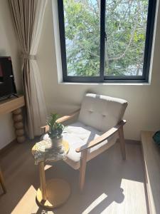 a living room with a couch and a window at Victoria home in Vĩnh Thái