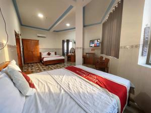a hotel room with two beds and a bedroom at Mimosa 7 Hotel - Phan Rang in Phan Rang–Tháp Chàm