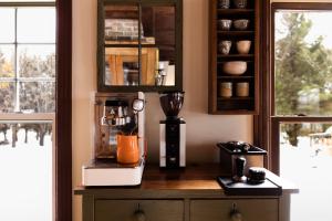 a kitchen with a blender on a wooden counter at Maison Hôte in Magog-Orford +30 photos