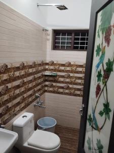 a bathroom with a toilet and a sink at Aditi Residency in Cochin