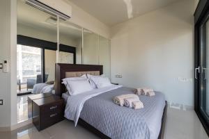 a bedroom with two beds and a mirror at Ixia Pool Villa with sea view roof top in Ixia +42 photos