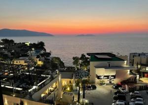 a view of a city with a parking lot and the ocean at Hotel Lusini in Vlorë