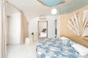 a bedroom with a blue and white bed in a room at My Suite Sorrento in Sorrento