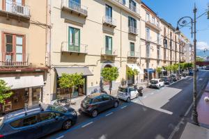 a city street with cars parked in front of buildings at My Suite Sorrento in Sorrento