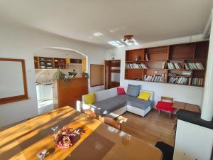 a living room with a couch and a table at Tau Forest Lodge in Solkan