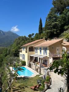 a villa with a swimming pool and a house at Des Ciappes et des Fées in Menton