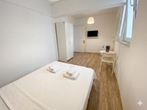 a room with a white table with two napkins on it at Alicante Otel - Adult Only in Bozcaada