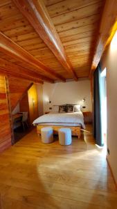 a bedroom with a bed and two white chairs at B&B Court1828 in Lillianes