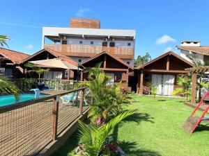 a view of a resort with a swimming pool at POUSADA ROSA e POESIA in Praia do Rosa