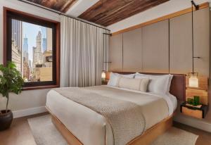 a bedroom with a large bed and a window at 1 Hotel Central Park in New York