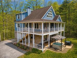 an aerial view of a blue house with a pool at Berg Stuga, Free Attraction Tickets, Game Room, Hot Tub, WIFI!!! in Townsend