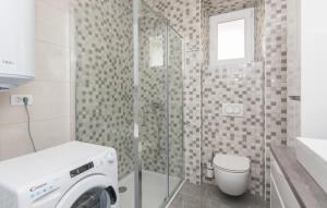 a bathroom with a washing machine and a toilet at Kuća za odmor Katini dvori in Novalja +16 photos