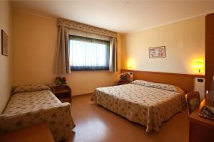 Postel nebo postele na pokoji v ubytování Sangallo Park Hotel