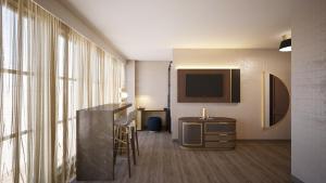 a hotel room with a desk and a television at The Berkeley Richmond, Outset Collection by Hilton in Richmond