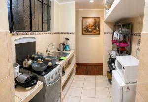a kitchen with pots and pans on a stove at Departamento Privado in Lima