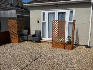 a group of chairs sitting outside of a house at Starfish Snug in Brixham