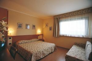 Postel nebo postele na pokoji v ubytování Sangallo Park Hotel