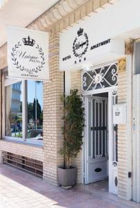 a building with a sign for a restaurant at Unique Apartahotel 2-3 in Torrevieja +5 photos