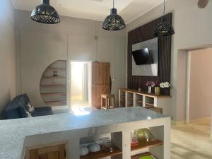 a kitchen with a counter and two pendant lights at Takasira Appartment Downtown 2 in Fort Dauphin