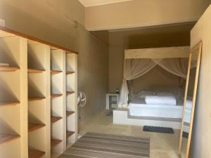 a bedroom with a bed with a canopy at Takasira Appartment Downtown 2 in Fort Dauphin