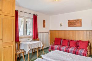 a bedroom with a bed and a table with red pillows at Ferienwohnung 1 in Wallgau