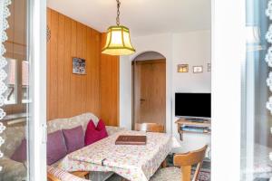 a living room with a table and a couch at Ferienwohnung 1 in Wallgau