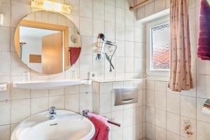 a bathroom with a sink and a mirror at Ferienwohnung 1 in Wallgau +15 photos