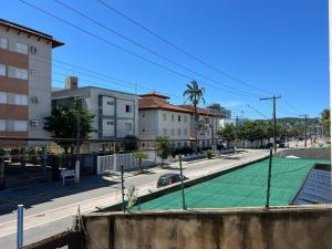 a tennis court on the side of a city street at Pousada in Guarujá