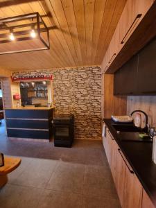 a kitchen with a counter and a stone wall at Dom Gościnny Nasza Góra in Szymbark
