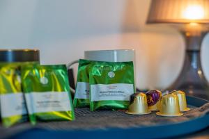 a table with two green bags of toothpaste and gold bells at Chambre De Charme Aux Chartrons in Bordeaux +12 photos