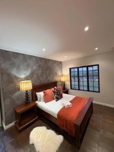 a bedroom with a large bed and a window at Acacia House in Winterton