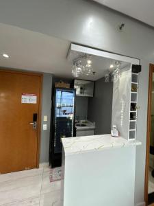 a kitchen with a white counter and a door at Tropical Executive Vista Pôr do Sol in Manaus