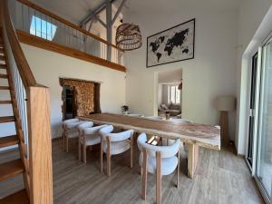 a dining room with a wooden table and chairs at Domaine de Quintessence in Saint-Justin +17 photos