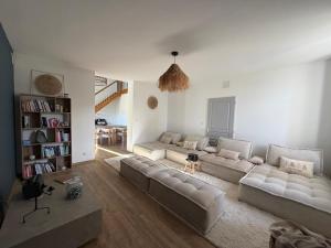 a living room with two couches and a table at Domaine de Quintessence in Saint-Justin