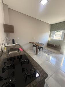 a kitchen with a counter top and a table at Amazon loft 03 in Sorriso