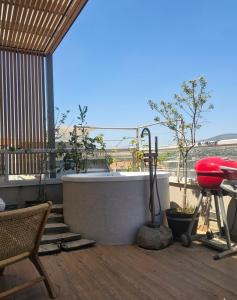 a bath tub sitting on top of a deck at מרום הגילבוע in Gid‘ona +7 photos