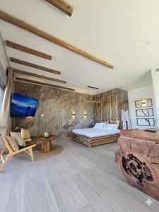 a bedroom with a bed and a couch and a table at מרום הגילבוע in Gid‘ona