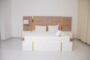 a bedroom with two beds with white sheets at Hotel Kilimanjaro in Luanda +57 photos